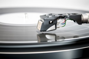 Close-up photo of a record player's needle touching a vinyl record.